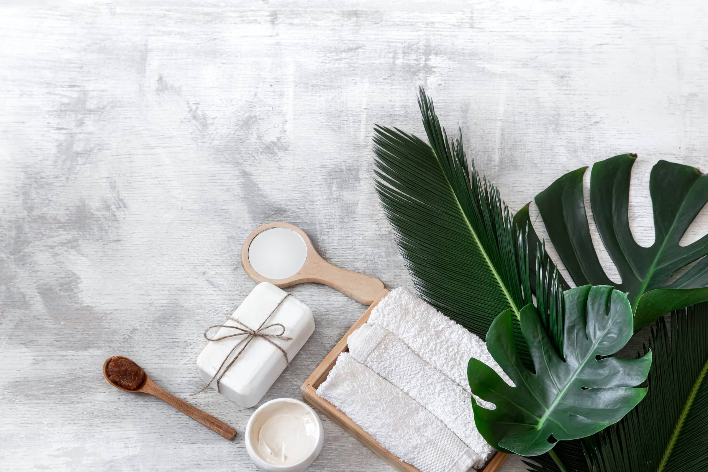 Spa towels and body care items with tropical leaves